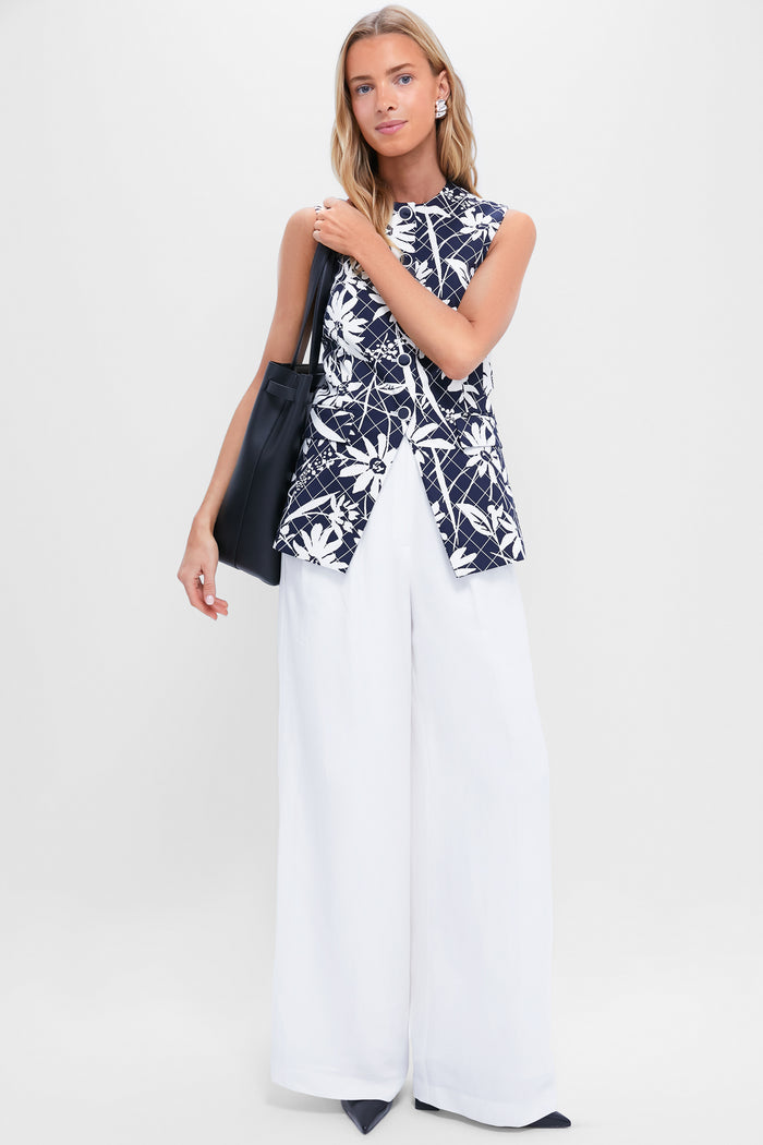 Model showcasing classic Black Eleanor Heels with pointed toes and block heels, paired with an effortless ensemble of navy top and white trousers, exuding a high-end, fun vibe.