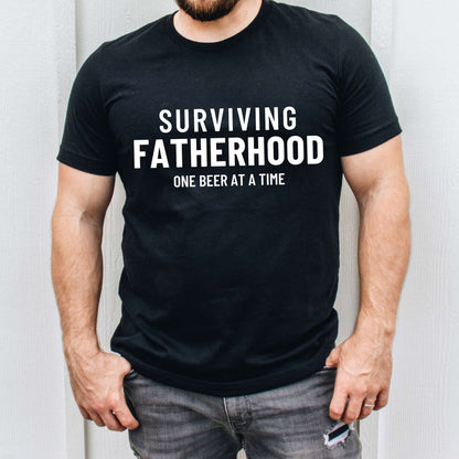 Surviving Fatherhood One Beer At A Time graphic t-shirt