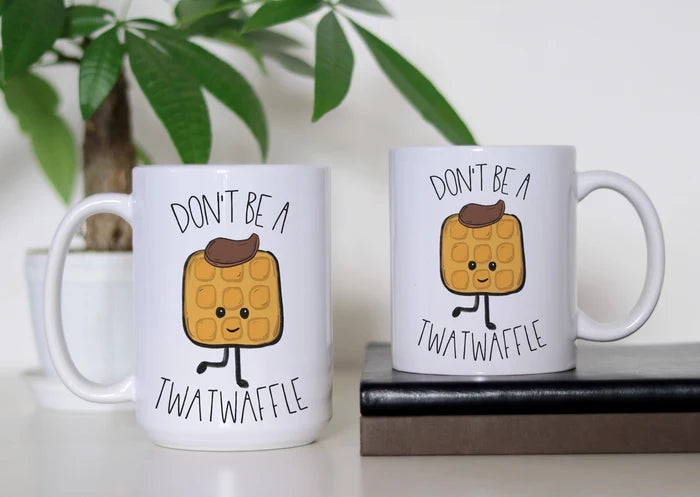 Syrup, Sass & Zero Patience white ceramic coffee mug featuring a cute illustrated waffle with butter and the funny phrase “Don’t Be a Twatwaffle,” available in 11 oz and 15 oz sizes.