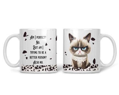 Funny grumpy cat coffee mug featuring an angry fluffy cat with bright blue eyes and black abstract accents.